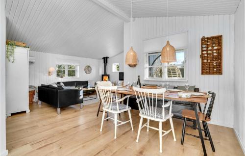 a dining room and living room with a table and chairs at A Stunning Home In Otterup With 3 Bedrooms And Wifi in Otterup
