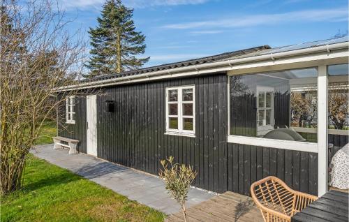 a black tiny house with a white window and a patio at A Stunning Home In Otterup With 3 Bedrooms And Wifi in Otterup