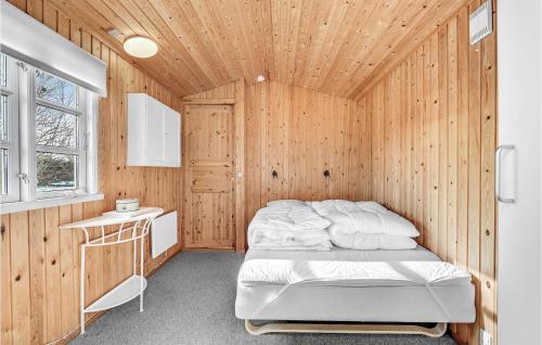 a bedroom with a bed in a wooden wall at A Stunning Home In Otterup With 3 Bedrooms And Wifi in Otterup
