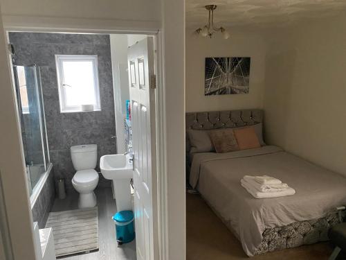 a small bedroom with a bed and a bathroom at Alder en-suite self catering with private shower 3 in Southampton