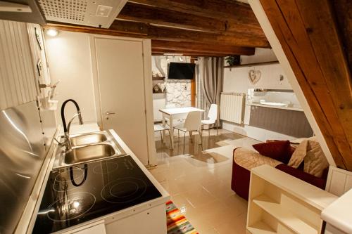 a small kitchen with a sink and a living room at Residenza Biennale Apartment in Venice