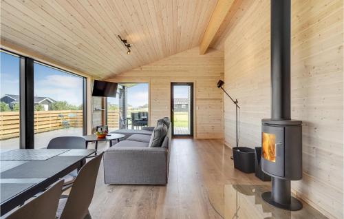a living room with a fireplace in a house at An Awesome Home In Storvorde With 4 Bedrooms And Wifi in Storvorde