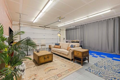 a living room with a couch and a table at The Explorer! Extra Game Room, Fire pit Sleeps 10! in Caldwell