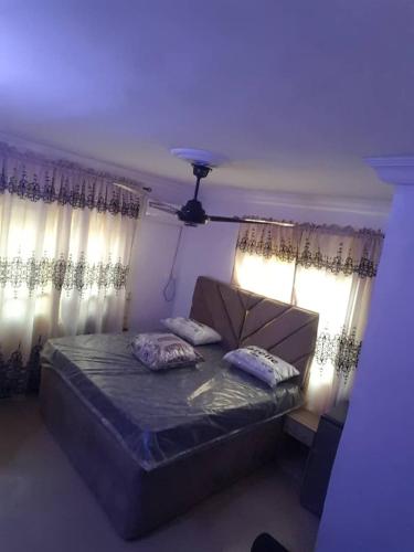 a bedroom with a bed with two pillows on it at 3JD Lavishly Furnished 3-Bed Apartment in Lagos