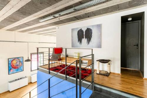 a room with a glass shelf with a table at Le Chai Raffiné: an old-school winery renovated for modern holidays in Rochecorbon