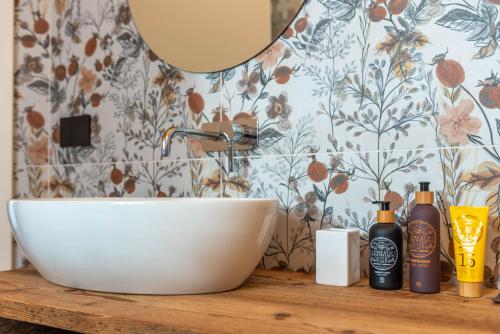 a bathroom with a sink and a mirror at B&B El Lares - B&B L'Avez in Canale dʼAgordo