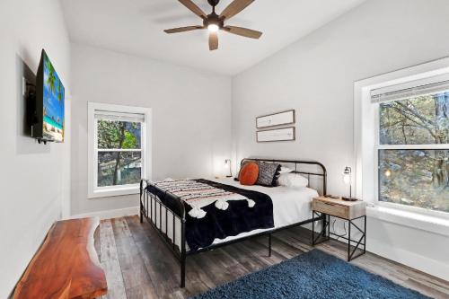 a bedroom with a bed and a ceiling fan at Barndo on the Blanco in Wimberley