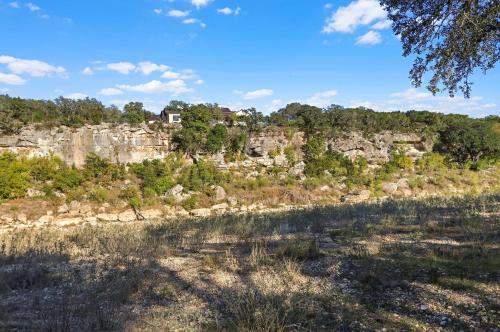 a house on top of a rocky mountain at Barndo on the Blanco in Wimberley