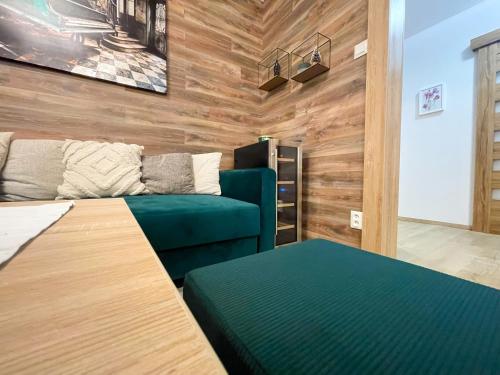 a living room with a couch and a green couch at Apartman Anita in Dunajská Streda