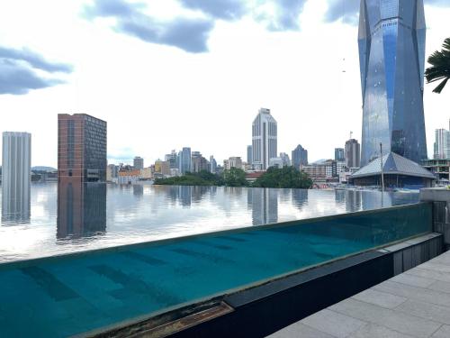 a large swimming pool with a view of the city at Opus Residences KL 118 View in Kuala Lumpur