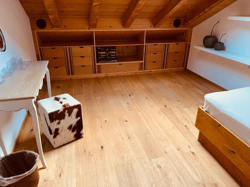 a bedroom with wooden floors and a wooden ceiling at Wally Luxus Lodge im Ferienhaus Magdalena in Mittenwald