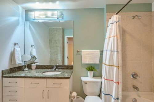 a bathroom with a toilet and a sink and a shower at 1700 Bassett, Unit 818 in Denver
