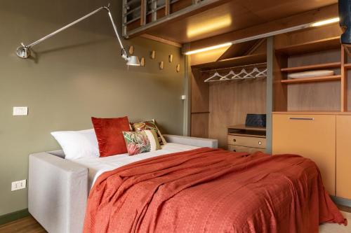 1 dormitorio con 1 cama grande con manta roja en Appartamento luminoso a 5 min da Porta Nuova en Turín