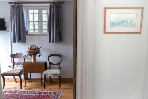 a door leading to a dining room with a table and chairs at The Rear of the Plough,Everdon. in Daventry