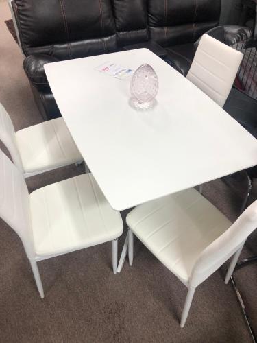 a white dining room table and two white chairs at Rare Find fully renovated 6 bedroom 3 bath and both levels in Calgary