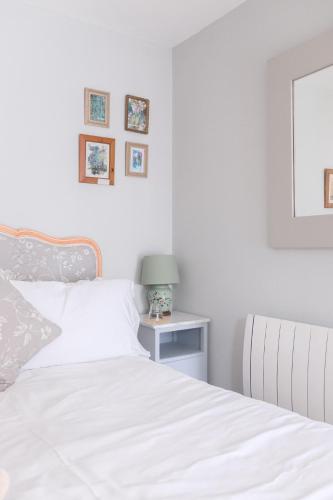 a bedroom with a bed and a table with a lamp at The Rear of the Plough,Everdon. in Daventry