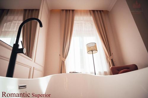 a room with a window and a white bath tub at Vili Apartments in Oradea