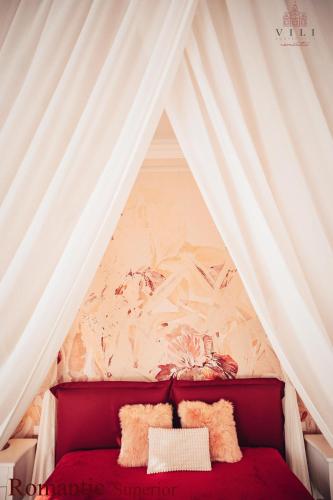 a room with a tent with a red couch at Vili Apartments in Oradea