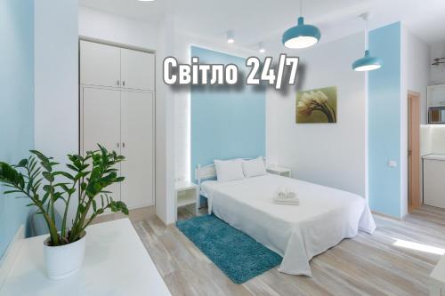a white bedroom with a bed and a plant at Basseynaya Apart Hotel in Kyiv