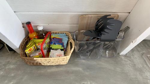 a basket filled with utensils and a utensil at Cashaw Cabin - Private Retreat with a Pool in Treasure Beach