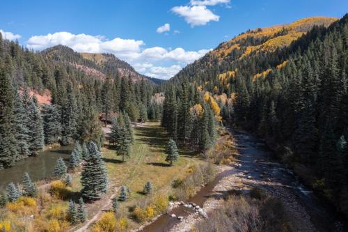 an aerial view of a river in a forest at Slippery Rock River Ranch in Dolores
