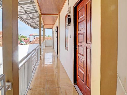 a corridor of a house with a door and a balcony at OYO 92054 Gala Residence in Jambi