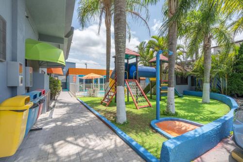 a playground at a resort with a slide at Hotel Conexão in Penha