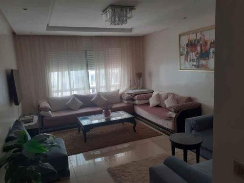 a living room with a couch and a table at Taroudant Calm Hous in Taroudant