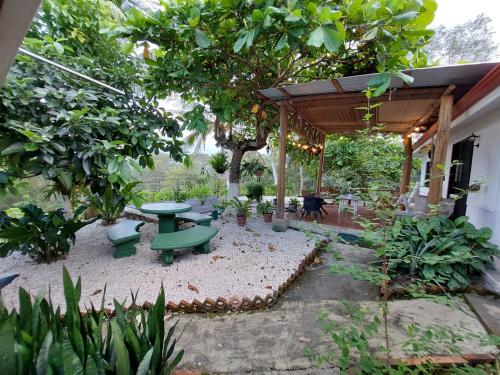 a garden with a picnic table and a tree at Private Mountain House With a Pool in Orotina