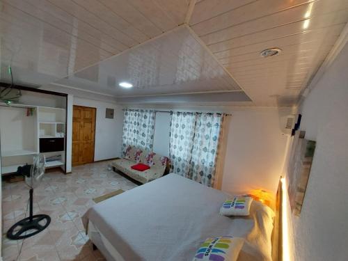 a bedroom with a bed and a couch in it at Private Mountain House With a Pool in Orotina