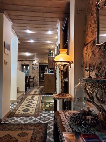 a hallway with a living room and a table with a lamp at VIRSA BOUTIQUE ROOMS in Ioannina