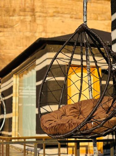 a brown chair sitting in front of a building at RUM STARDUST lUXURY CAMP in Wadi Rum