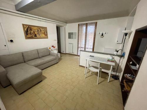 a living room with a couch and a table at Lila House in Turin