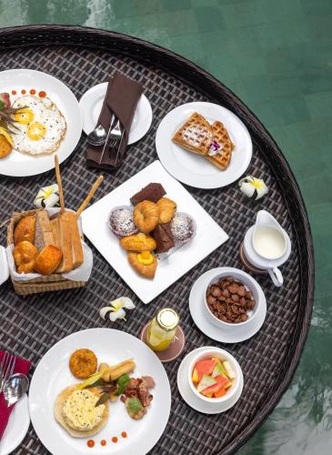 a table full of plates of food on a table at Ayana Sea in Wadduwa