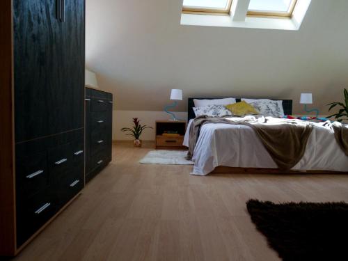 a bedroom with a bed with a dresser and a dresser at Altavista mountain apartment in Samokov