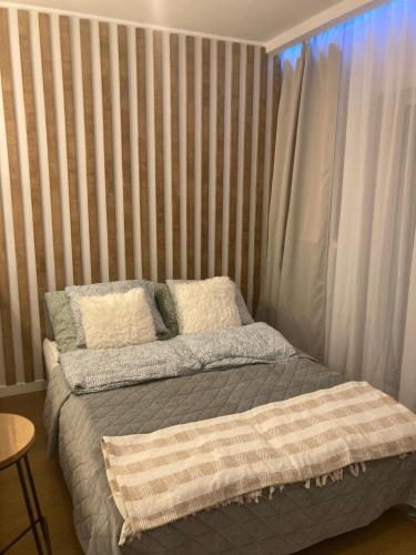 a bed with two pillows on it in a bedroom at Yellow Stone Apartment in Szczecin