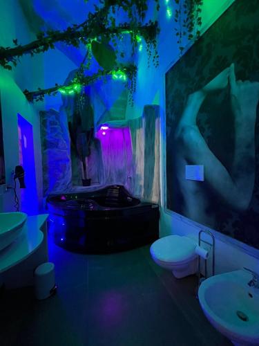 a bathroom with a tub and a toilet and a sink at The Bridge Suites in Gravina in Puglia