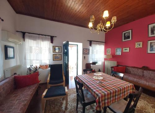 a living room with a table and a couch at Xenia's Traditional House in Andros