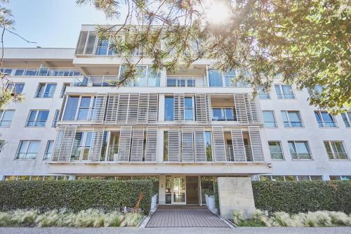 a large white building with windows and a walkway at Apartament Riviera z tarasem - Playa Baltis in Międzyzdroje