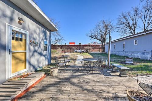 a patio with a table and chairs and a building at Cozy Rogers Home with Patio, Near Downtown! in Rogers