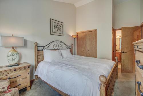 a bedroom with a white bed with a wooden headboard at Village Point in Breckenridge