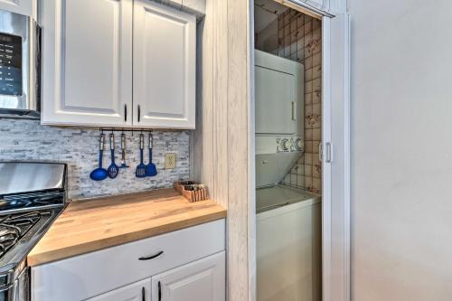 a kitchen with white cabinets and a refrigerator at Cozy Cape May Escape Near Beaches and Golfing! in Cape May