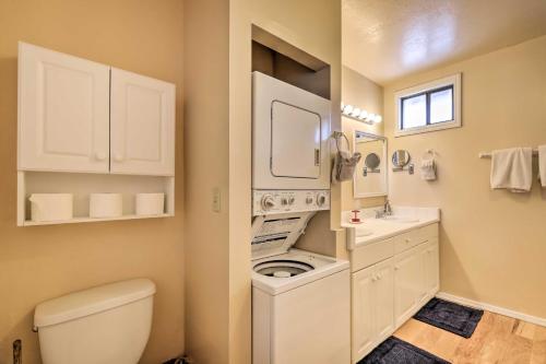 a bathroom with a washer and dryer in it at Williams Vacation Rental with Mountain View! in Williams
