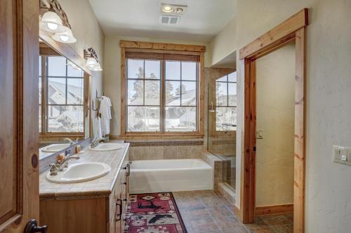 a bathroom with two sinks and a tub and a bath tub at Mountain Thunder #604 in Breckenridge