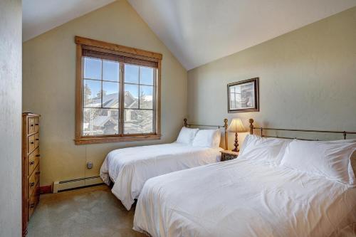 a bedroom with two beds and a window at Mountain Thunder #604 in Breckenridge
