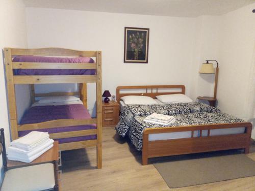 a bedroom with two bunk beds and a table at Casa Negritella in Serrada