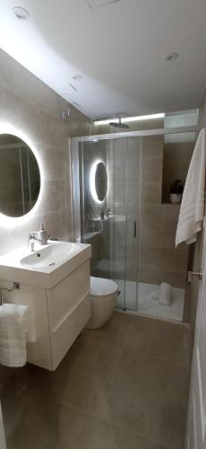 a bathroom with a sink and a toilet and a shower at Luxury Old Town SP7 in Málaga
