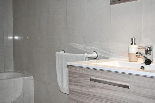 a bathroom with a sink and a toilet at Apartamento LLac,bahía de Alcudia. in Alcudia