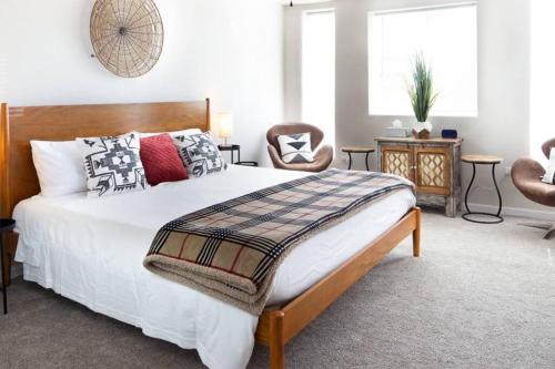 a bedroom with a large bed and a chair at The Lagartija @ Old Town with King Bed in Albuquerque