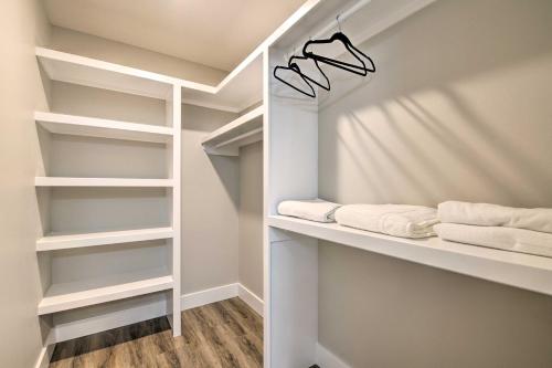 a walk in closet with white shelves and towels at Pet-Friendly Ozark Home with Yard and Patio in Ozark
